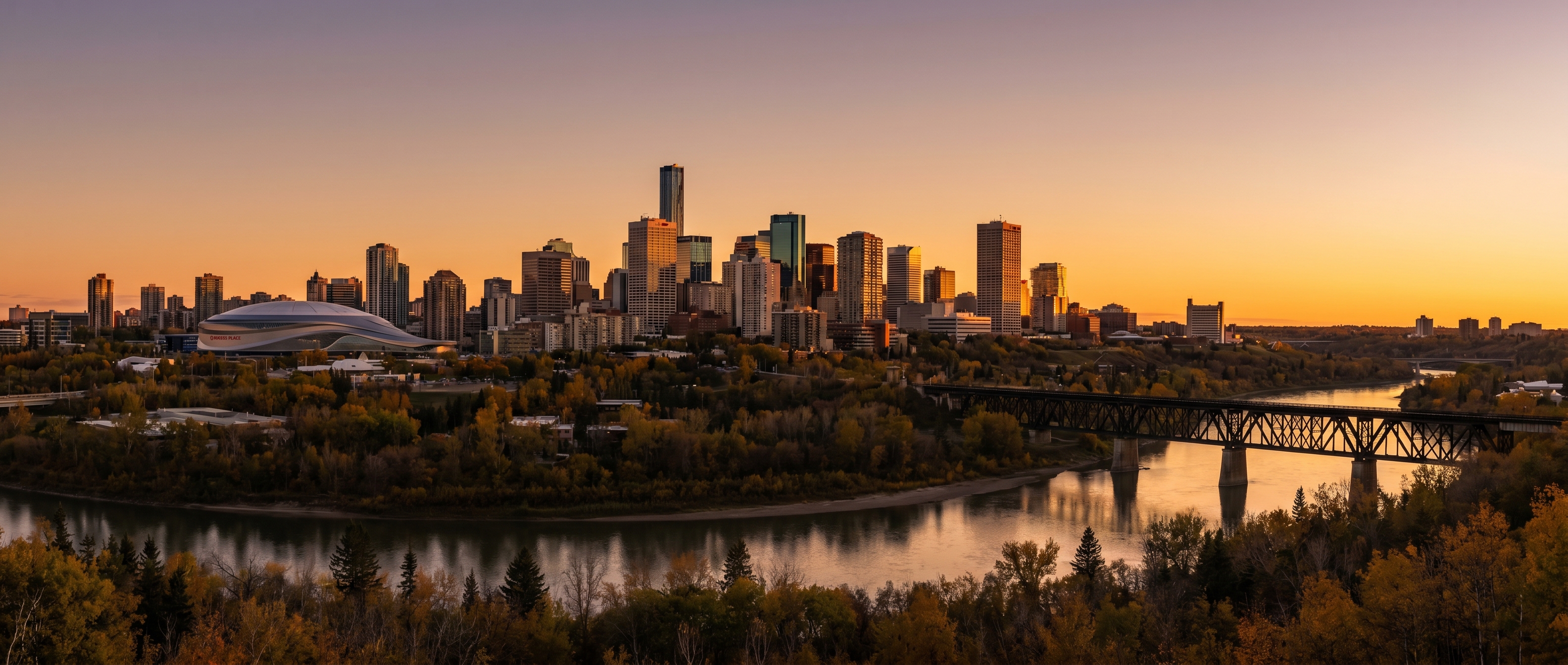 Edmonton downtown skyline at golden hour with the North Saskatchewan River, High Level Bridge, and autumn River Valley