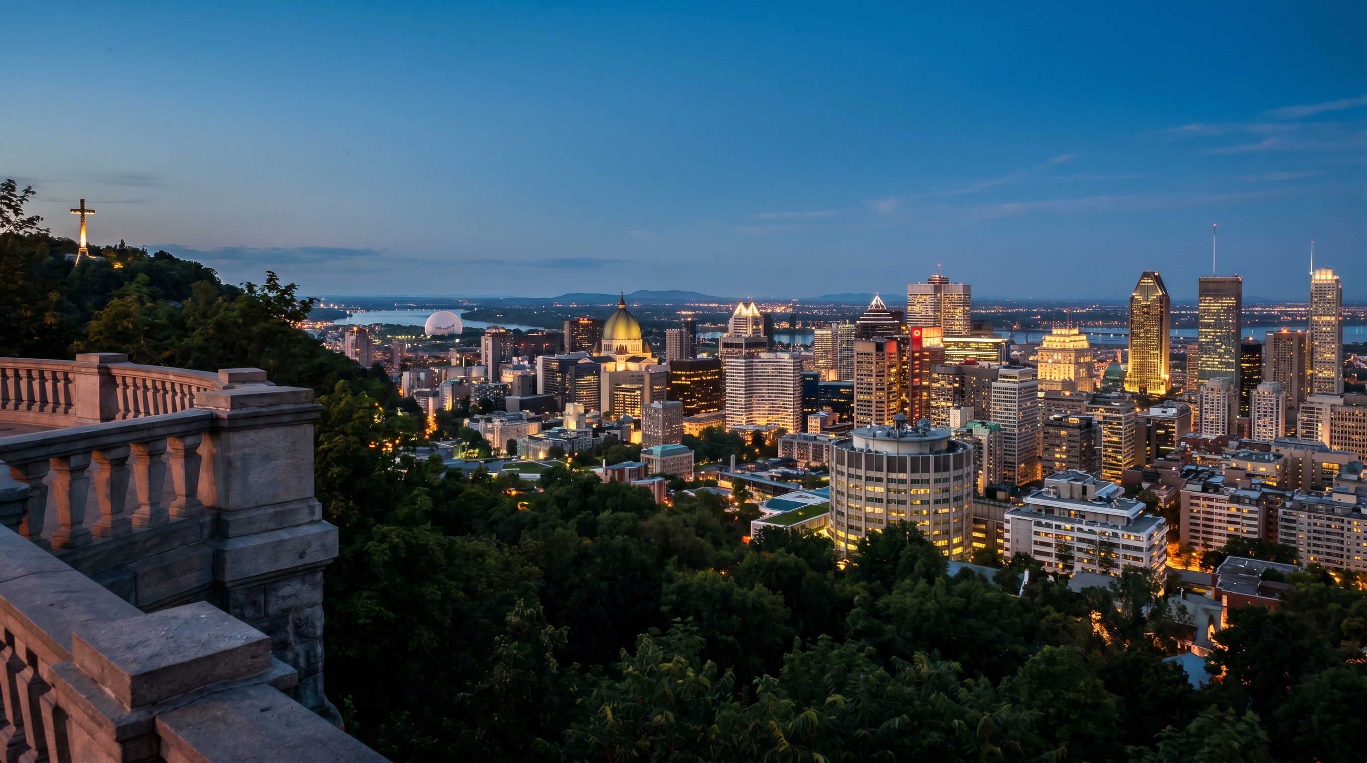Montreal downtown skyline from Mont-Royal at twilight with the Saint Lawrence River beyond